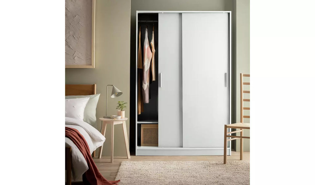 Home Nova 2-door sliding wardrobe in white with wood-effect finish

Modern white sliding wardrobe with two doors and space-saving design

Nova wardrobe with two hanging sections and bottom storage shelves

Contemporary 2-door white wardrobe with understore cubbies

Space-saving sliding wardrobe for clothes, shoes, and accessories

White sliding wardrobe with central divider and fixed shelves

Stylish Home Nova 2-door wardrobe with particleboard construction

Bedroom wardrobe in white with sliding doors and 
